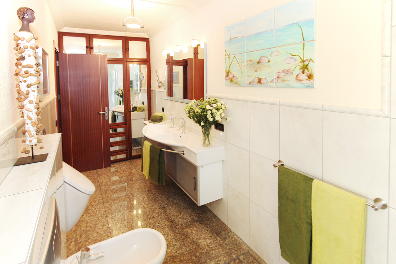 bathroom equipped with Shower, toilet, bidet, urinal, wardrobes.